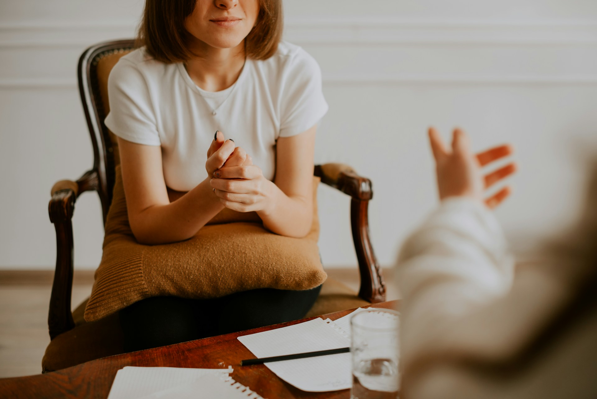 Woman sitting in chair talking therapist